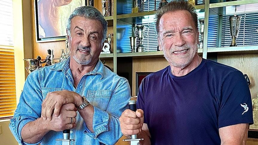 Sylvester Stallone and Arnold Schwarzenegger carving pumpkins in 2022.